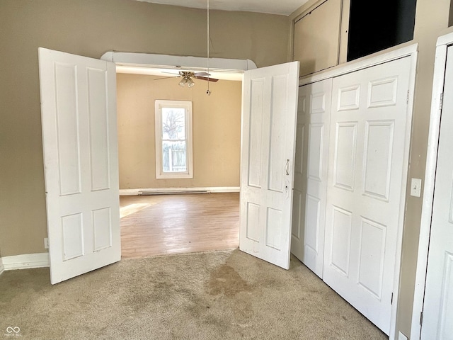 unfurnished bedroom featuring ceiling fan and carpet floors