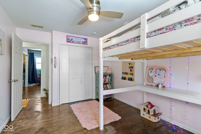 bedroom with ceiling fan, a closet, and dark hardwood / wood-style flooring