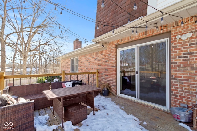 snow covered deck with outdoor lounge area