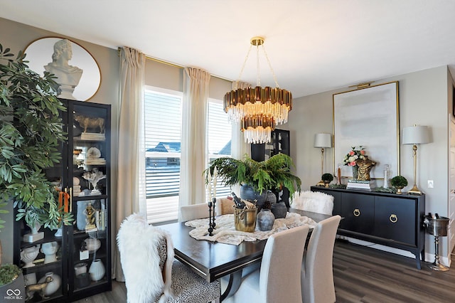 dining area featuring dark hardwood / wood-style floors and a chandelier