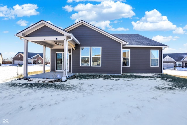 snow covered property featuring ceiling fan