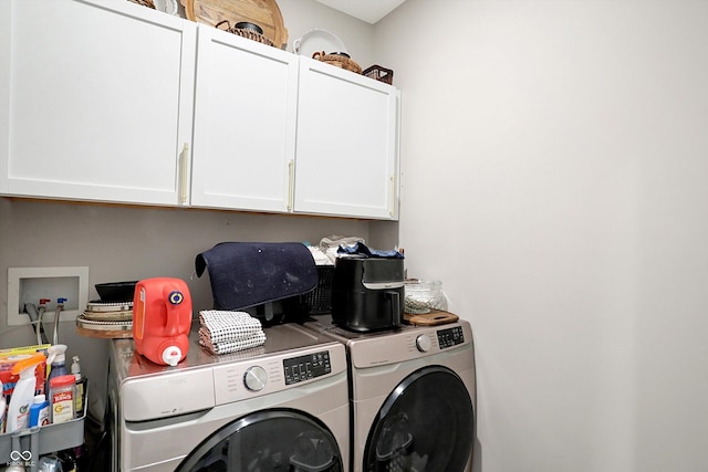 laundry area featuring washer and dryer and cabinets