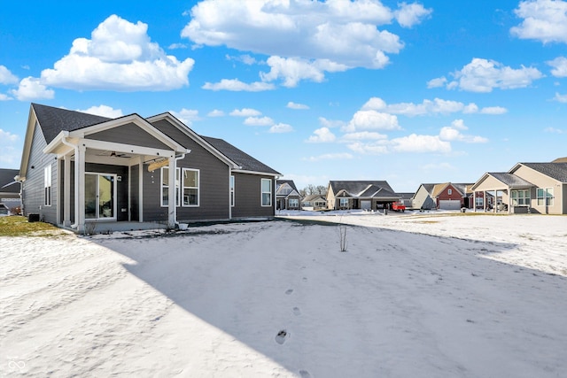 view of snow covered rear of property