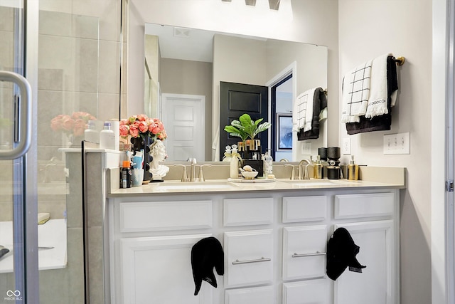 bathroom featuring vanity and a shower with shower door