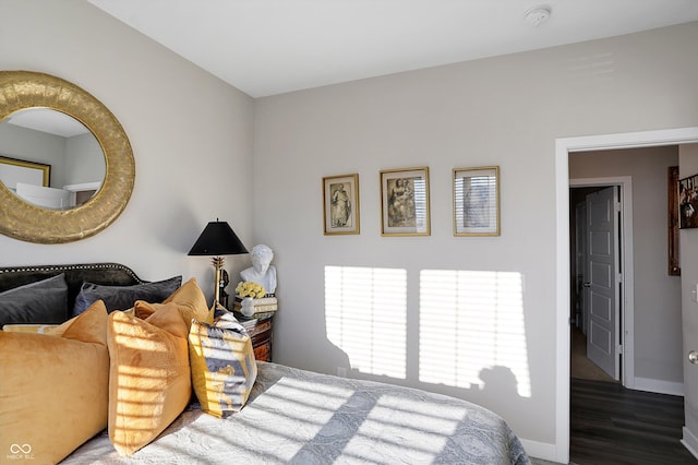 bedroom with dark hardwood / wood-style floors