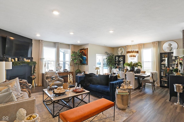 living room with dark hardwood / wood-style floors and a textured ceiling