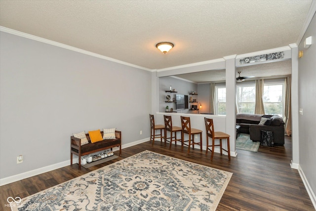 interior space featuring dark hardwood / wood-style flooring, crown molding, and a textured ceiling