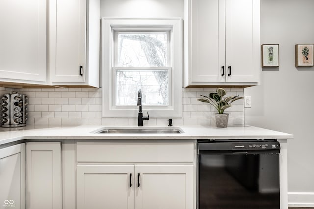 kitchen featuring white cabinetry, black dishwasher, sink, and tasteful backsplash