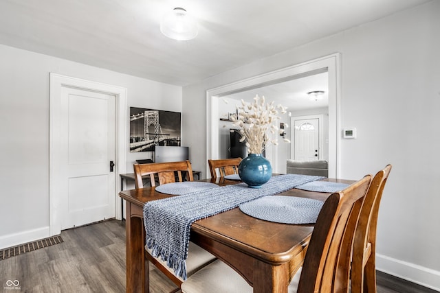 dining area featuring dark hardwood / wood-style flooring