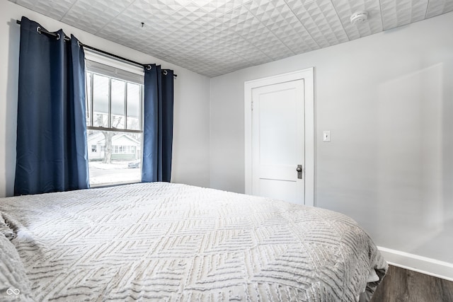 bedroom with dark wood-type flooring