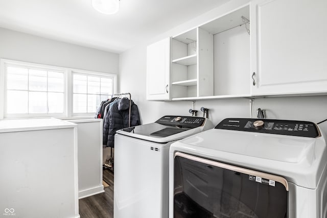 laundry area with washer and dryer, dark wood-type flooring, and cabinets