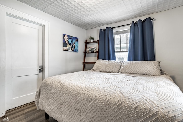 bedroom featuring dark hardwood / wood-style flooring