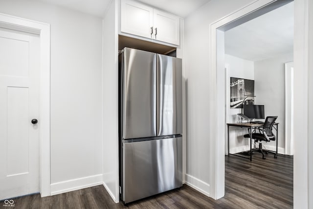 kitchen featuring white cabinetry, dark hardwood / wood-style floors, and stainless steel fridge