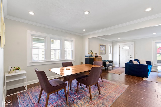 dining space featuring crown molding and dark wood-type flooring