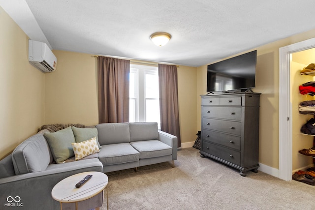 living room featuring light colored carpet, a textured ceiling, and a wall unit AC