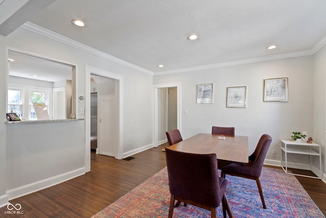 dining area featuring dark hardwood / wood-style floors and crown molding