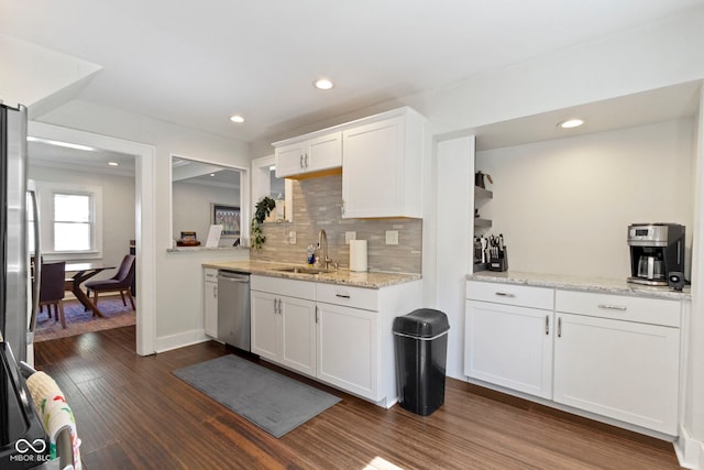 kitchen featuring dishwasher, sink, white cabinetry, dark hardwood / wood-style floors, and decorative backsplash