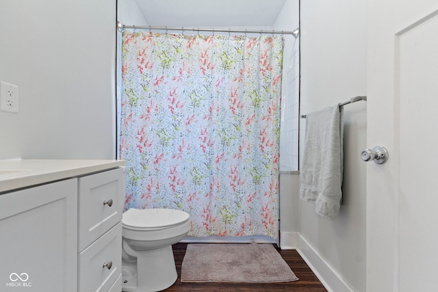 bathroom with vanity, toilet, walk in shower, and wood-type flooring