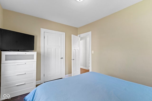 bedroom featuring dark wood-type flooring