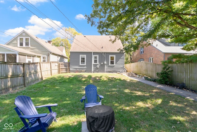 rear view of house with a yard