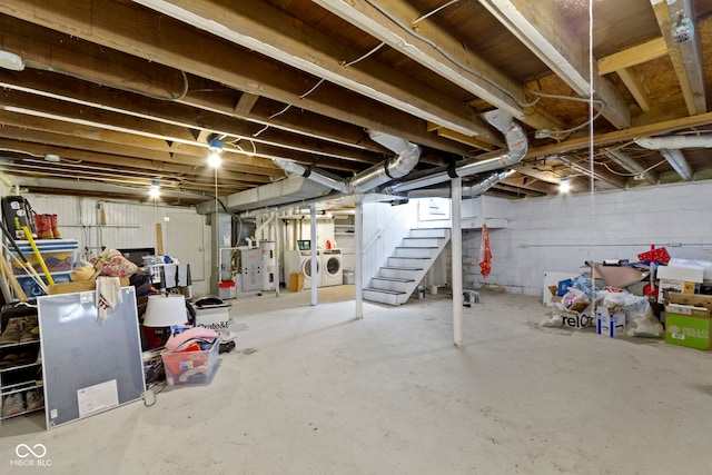 basement featuring water heater and washing machine and clothes dryer