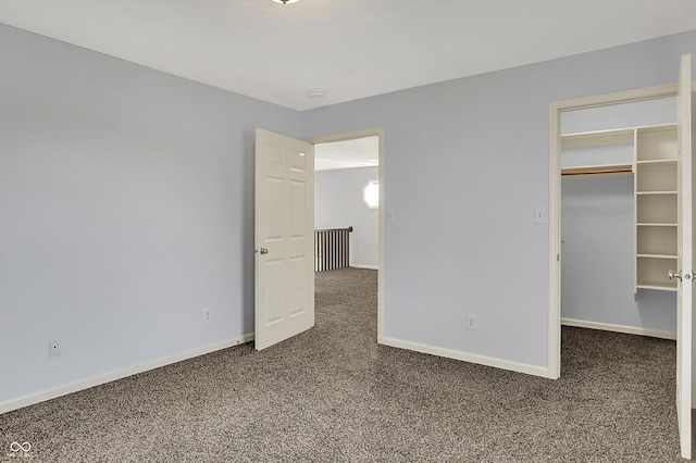 386 White Oak Ln, Greenwood, IN 46142 - unfurnished bedroom featuring baseboards, carpet flooring, and a walk in closet