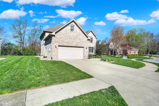 386 White Oak Ln, Greenwood, IN 46142 - view of front of home featuring a garage, a front yard, brick siding, and driveway
