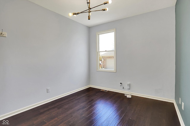 386 White Oak Ln, Greenwood, IN 46142 - empty room featuring a notable chandelier, baseboards, visible vents, and dark wood finished floors