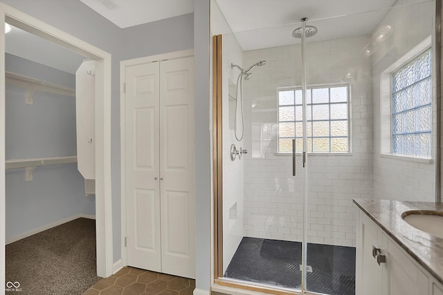 386 White Oak Ln, Greenwood, IN 46142 - bathroom with a stall shower, vanity, a closet, and tile patterned flooring