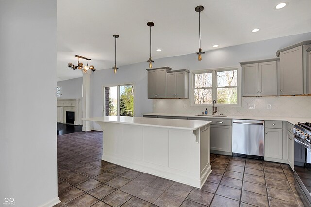 386 White Oak Ln, Greenwood, IN 46142 - kitchen with stainless steel dishwasher, decorative backsplash, gray cabinets, and range with gas stovetop