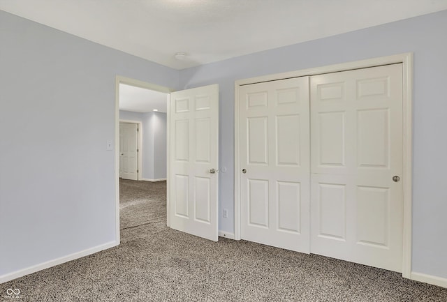 386 White Oak Ln, Greenwood, IN 46142 - unfurnished bedroom with baseboards, a closet, and carpet floors