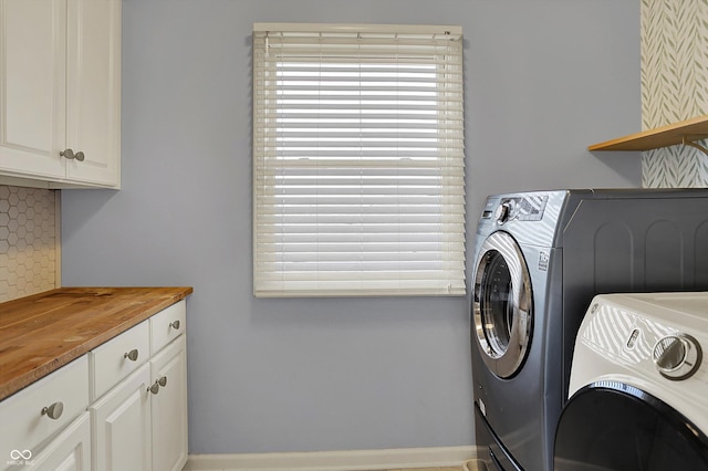 386 White Oak Ln, Greenwood, IN 46142 - clothes washing area with washer and dryer, cabinet space, and baseboards