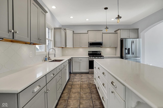 386 White Oak Ln, Greenwood, IN 46142 - kitchen with a sink, backsplash, gray cabinets, and appliances with stainless steel finishes