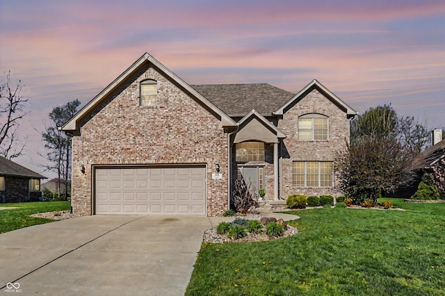 386 White Oak Ln, Greenwood, IN 46142 - view of front of home featuring concrete driveway, a yard, and brick siding