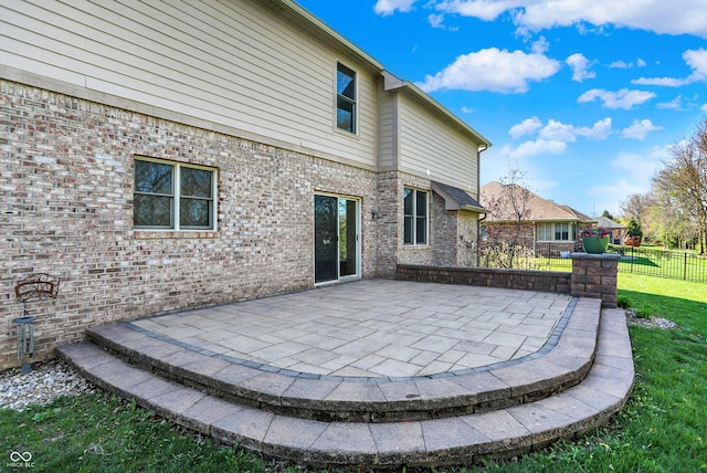 386 White Oak Ln, Greenwood, IN 46142 - back of house with brick siding, a yard, fence, and a patio area