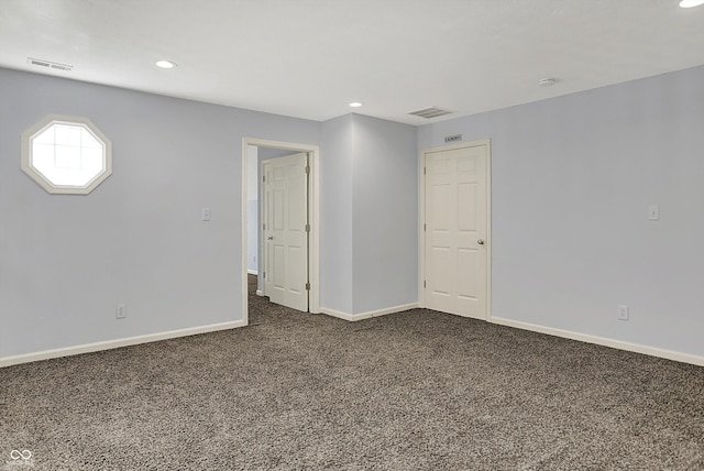 386 White Oak Ln, Greenwood, IN 46142 - unfurnished room featuring baseboards, recessed lighting, dark colored carpet, and visible vents