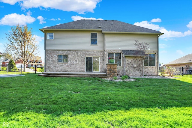 386 White Oak Ln, Greenwood, IN 46142 - back of property featuring fence, brick siding, and a lawn