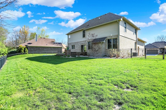 386 White Oak Ln, Greenwood, IN 46142 - rear view of house featuring a lawn, central air condition unit, and a fenced backyard