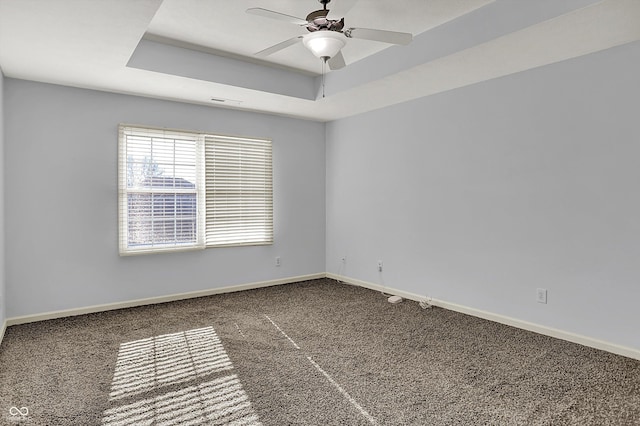 386 White Oak Ln, Greenwood, IN 46142 - carpeted empty room with a raised ceiling, baseboards, and a ceiling fan