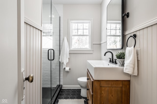 bathroom with a shower with door, toilet, and vanity