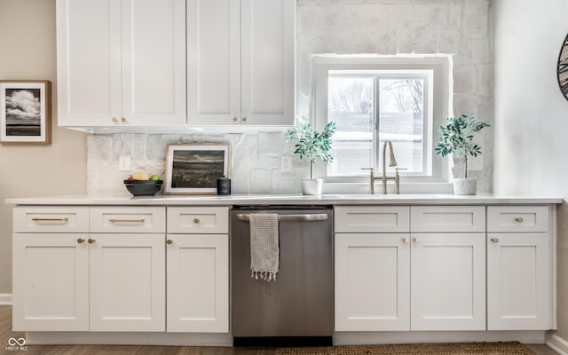 kitchen featuring white cabinets, backsplash, and stainless steel dishwasher