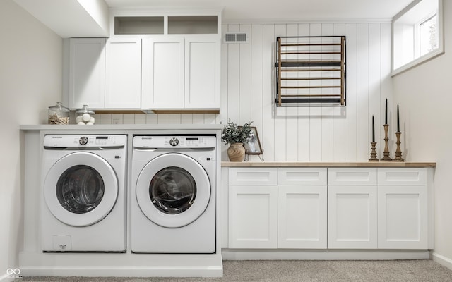 laundry room featuring cabinets, light carpet, and independent washer and dryer