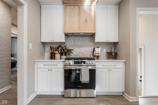 kitchen with stainless steel range with gas cooktop and white cabinets