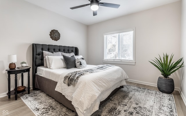 bedroom with ceiling fan and light hardwood / wood-style floors