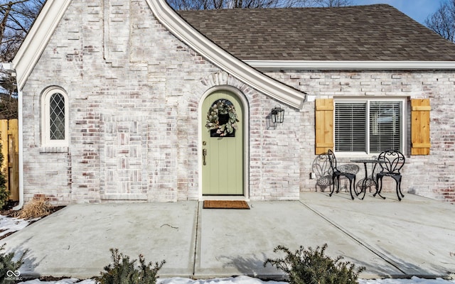 view of exterior entry featuring a patio