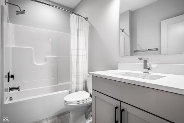 bathroom featuring toilet, shower / bath combo, and vanity