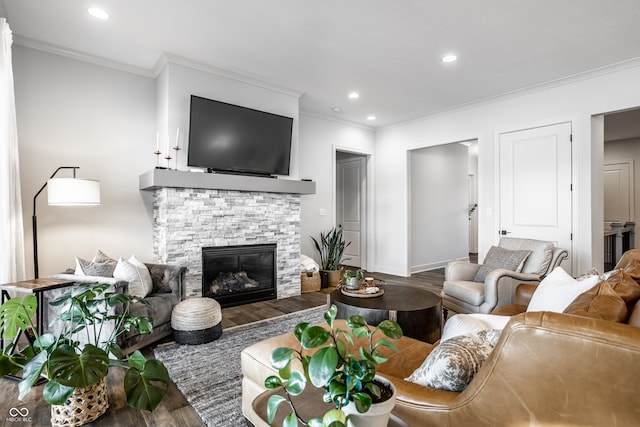 living room featuring crown molding, a fireplace, wood finished floors, and recessed lighting