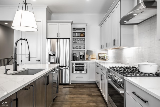 kitchen featuring wall chimney exhaust hood, light stone counters, stainless steel appliances, white cabinetry, and pendant lighting