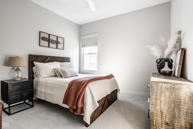 carpeted bedroom with a ceiling fan and baseboards