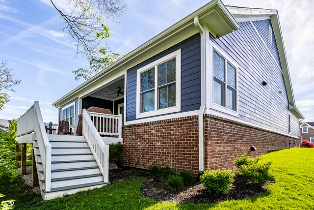 20188 Hampton Park Dr, Westfield, IN 46074 - view of property exterior featuring a yard, stairs, ceiling fan, and brick siding